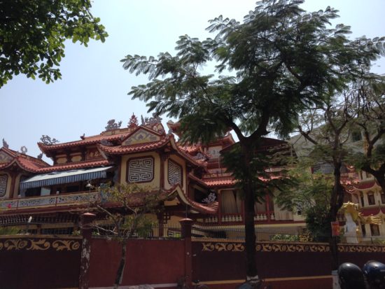 Photo of a large temple behind some trees in Quy Nhon, Vietnam