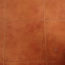 Image contains a series of orange-red tiles with a black and white dog laying down in the bottom-right hand corner. On the left side, a series of metal dog bowls sit empty.