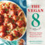 Image contains two columns with the left column containing a blue tablecloth and a light green napkin. On the tablecloth, a white plate is filled with spaghetti and meatballs. Just below the plate, there is a small dish of crushed chili peppers. In the right-hand column, there is text on a white stone background that says "The Vegan 8" above a small illustration of leaves. Below this illustration, there is text that says "100 simple, delicious recipes made with 8 ingredients or less" and then a series of small dots in a single line. Below these dots, there is text that says "Brandi Doming Creator of The Vegan 8".